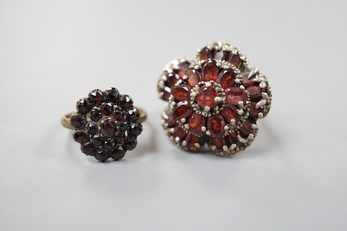 A Victorian garnet cluster set gilt metal dress ring, one other garnet set cluster ring and a garnet paste set hinged bangle.